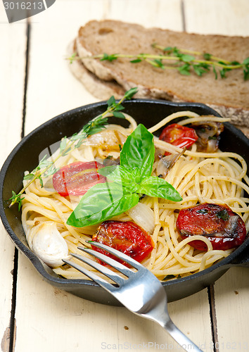 Image of spaghetti pasta with baked cherry tomatoes and basil 