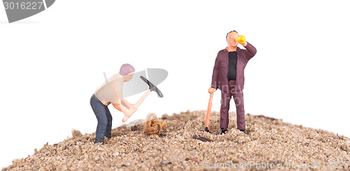 Image of Miniature workers with pickaxes