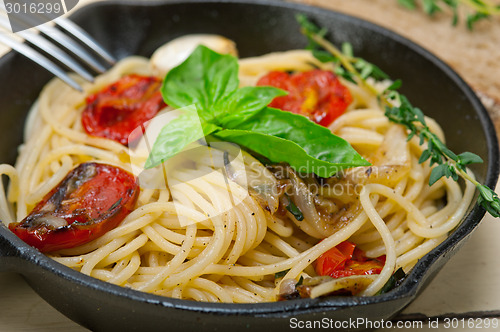 Image of spaghetti pasta with baked cherry tomatoes and basil 