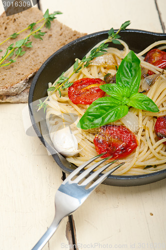 Image of spaghetti pasta with baked cherry tomatoes and basil 