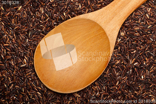 Image of Wooden spoon on Thai Red Cargo rice