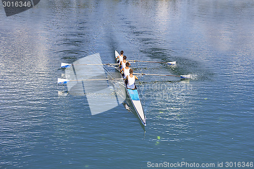 Image of Four men rowing 
