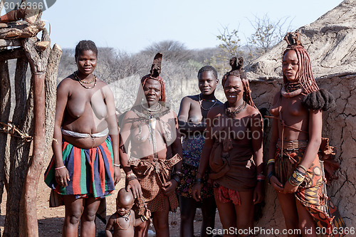 Image of Himba and zemba woman with ornaments on the neck in the village