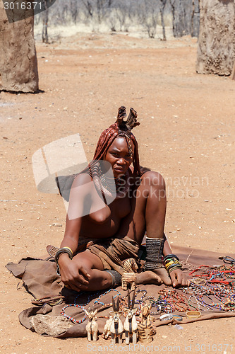 Image of Himba girl with souvenirs for sale in traditional village