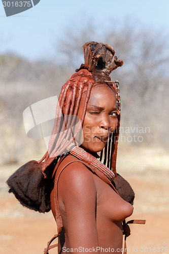 Image of Himba woman with ornaments on the neck in the village