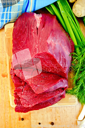 Image of Meat beef with ginger on wooden board