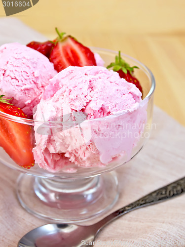 Image of Ice cream strawberry in glass goblet on napkin