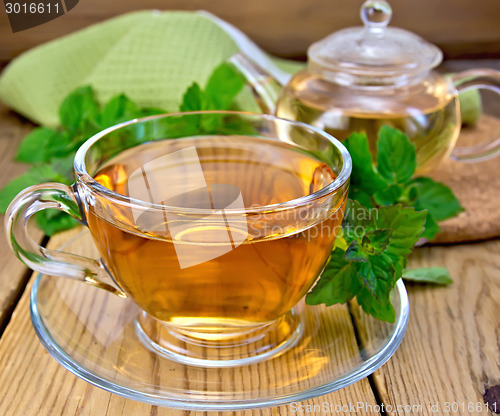 Image of Tea with mint and napkin on wooden board