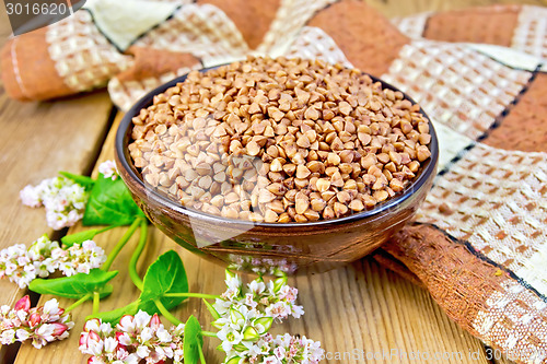 Image of Buckwheat in bowl with flower and napkin on board