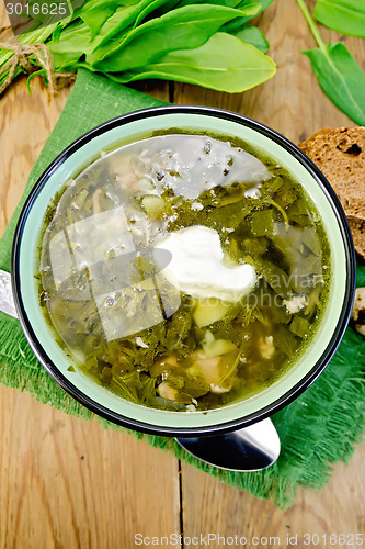 Image of Soup green of sorrel and spinach with sour cream on board