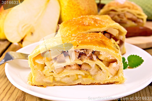 Image of Strudel with pears in bowl on board