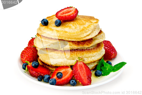 Image of Flapjacks with strawberries and blueberries in plate