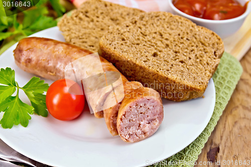 Image of Sausages pork grilled in plate with bread on board