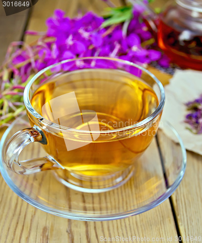 Image of Tea from fireweed in glass cup on board