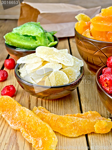 Image of Candied ginger and fruit in bowl on board