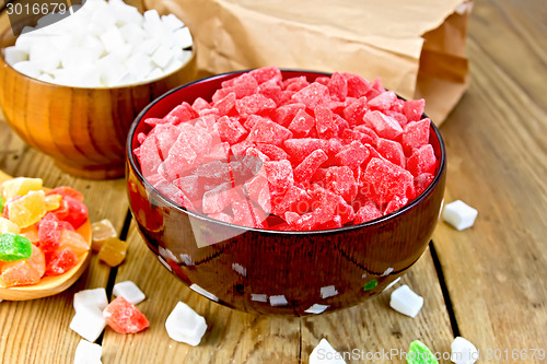 Image of Candied fruit colored in bowl and spoon on board