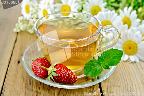 Image of Tea with strawberries and daisies on board