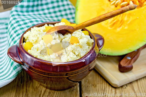 Image of Porridge millet with pumpkin and wooden spoon