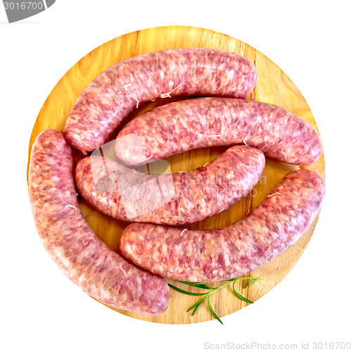 Image of Sausages pork with rosemary on round board