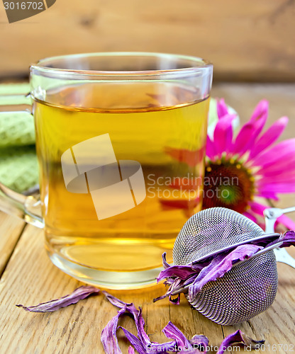 Image of Tea from Echinacea in glass mug with strainer on board