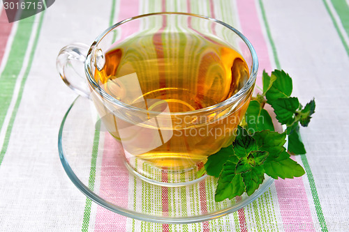 Image of Tea with mint in cup on napkin