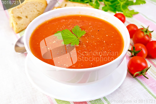 Image of Soup tomato in bowl on linen napkin