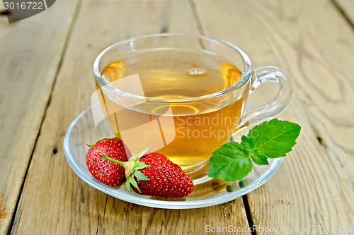 Image of Tea with strawberries and mint on board
