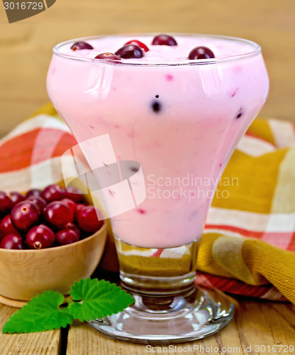 Image of Yogurt thick with cranberries and napkin on board