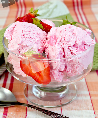 Image of Ice cream strawberry in glass goblet on tablecloth