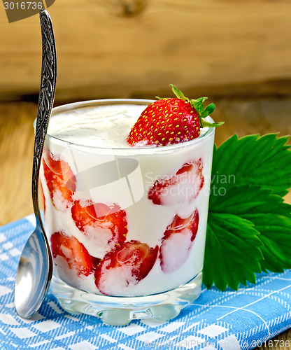 Image of Yogurt thick with strawberries and leaves on board