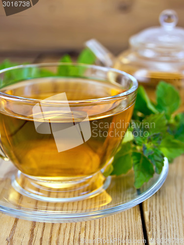 Image of Tea with mint and teapot on wooden board