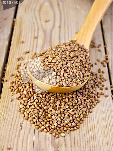 Image of Buckwheat in wooden spoon on board