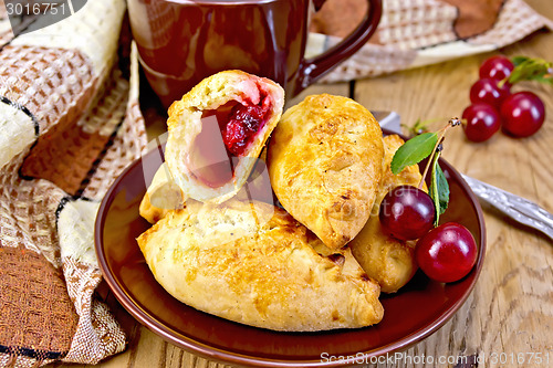 Image of Pies with cherry on board