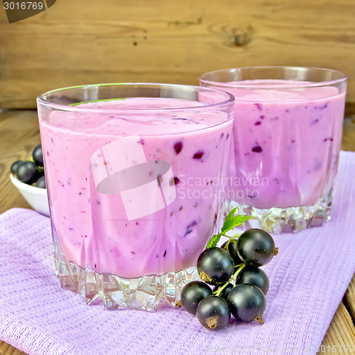 Image of Milkshake with black currants on napkin