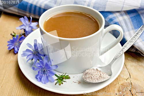 Image of Chicory drink in white cup with flower and spoon on board