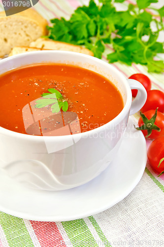 Image of Soup tomato in bowl with tomatoes on linen napkin
