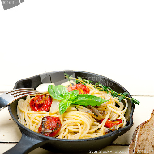 Image of spaghetti pasta with baked cherry tomatoes and basil 