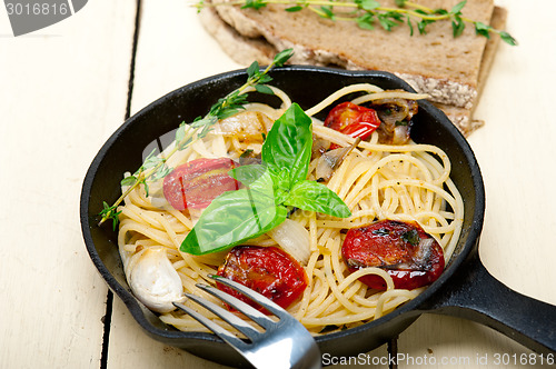 Image of spaghetti pasta with baked cherry tomatoes and basil 