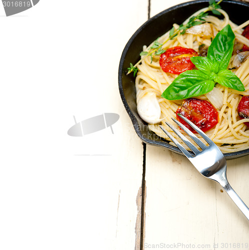 Image of spaghetti pasta with baked cherry tomatoes and basil 