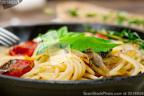 Image of spaghetti pasta with baked cherry tomatoes and basil 