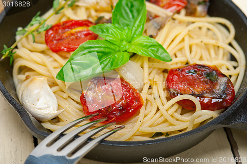 Image of spaghetti pasta with baked cherry tomatoes and basil 