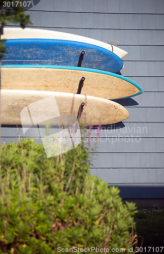 Image of worn surfboards hanging from trailer house Montauk New York USA