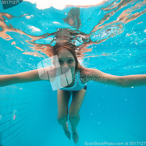 Image of Female with eyes open underwater in swimming pool