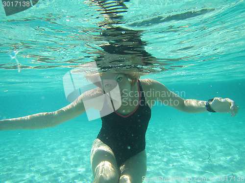 Image of Female with eyes open underwater in ocean