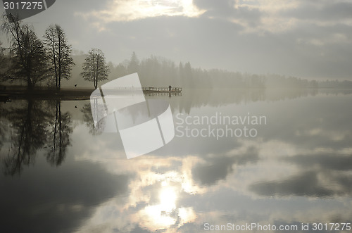 Image of summer landscape, lake and jetty in fog