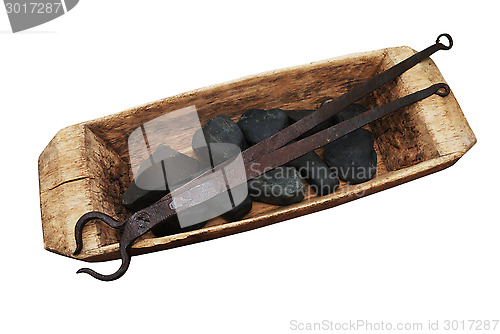 Image of old wooden trough, stones and pliers on a white