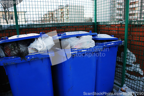 Image of three blue plastic garbage