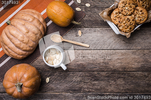 Image of pumpkins and cookies with nuts in Rustic style 