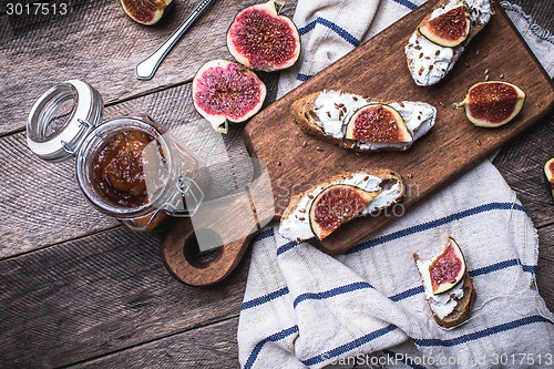 Image of rustic style tasty Bruschetta with jam and figs on napkin