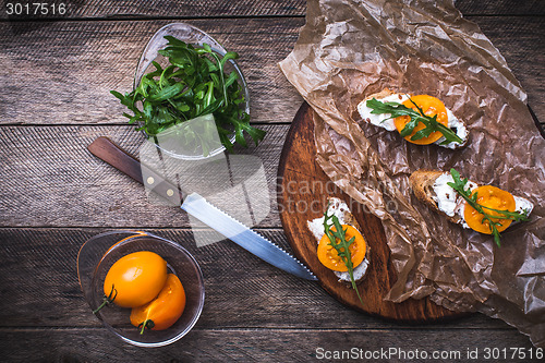 Image of rustic style Bruschetta snacks with tomatoes and salad rocket 